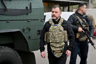 Ukraine's Minister of Internal Affairs Igor Klimenko walks outside a supermarket following a shooting in Kyiv on 18 April 2026